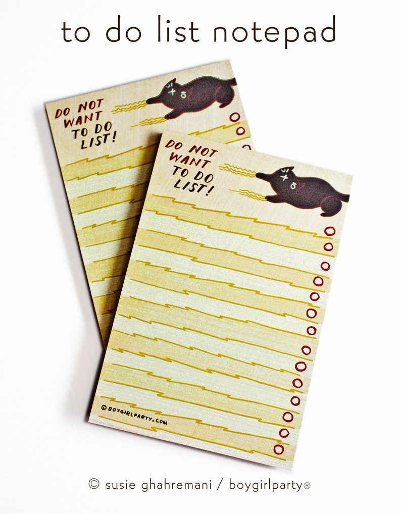 May include: A notepad with a black cat illustration and the text "Do Not Want To Do List!" on each page. The notepad has a yellow and white striped background.