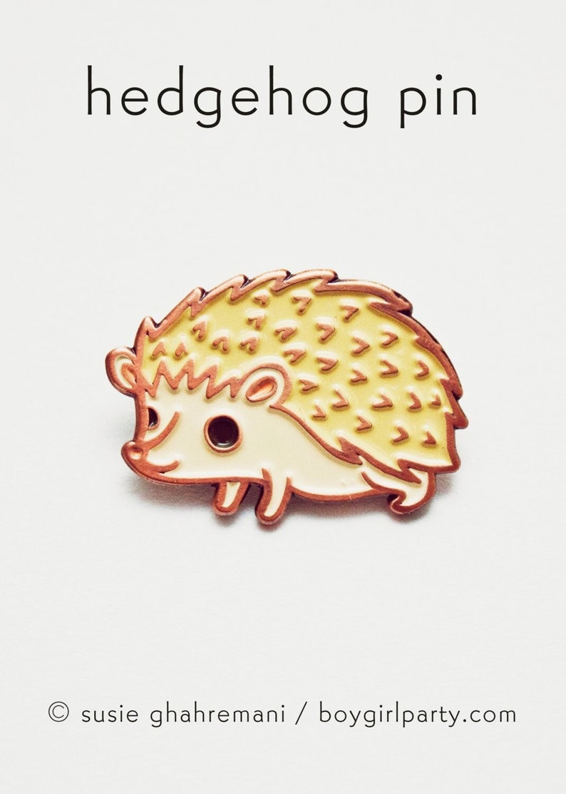 Adorable little hedgehog enamel pin by susie ghahremani / boygirlparty - the perfect gift for hedgehog enthusiasts!