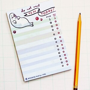 May include: A notepad with the text "to do list notepad" at the top. The notepad has a seal illustration and the text "do not want to do today!" A yellow pencil is next to the notepad.