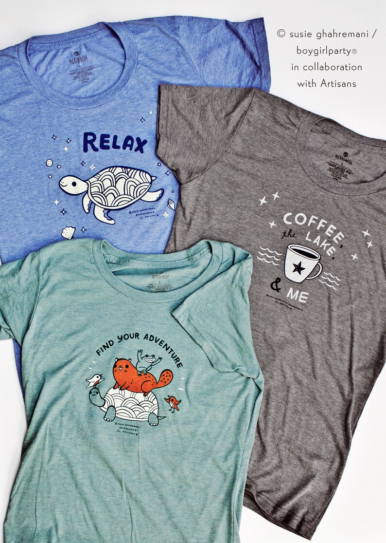 May include: Three t-shirts with different designs. The first t-shirt is blue with a white turtle and the text "RELAX". The second t-shirt is gray with a white coffee cup and the text "COFFEE the LAKE & ME". The third t-shirt is teal with a white turtle and the text "FIND YOUR ADVENTURE".