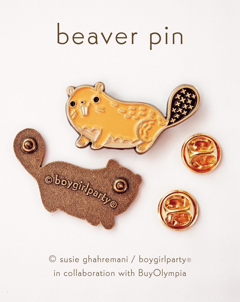 May include: A gold-colored enamel pin featuring a cartoon beaver with a brown tail. The beaver is yellow with a light brown belly and has a small, white tooth showing. The pin is on a white background and has a text overlay that reads "beaver pin".