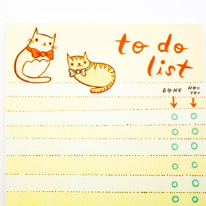 May include: A yellow to-do list notepad with a cat illustration and the text "to do list". The notepad has a dotted line pattern and a column for marking tasks as done or not yet done.