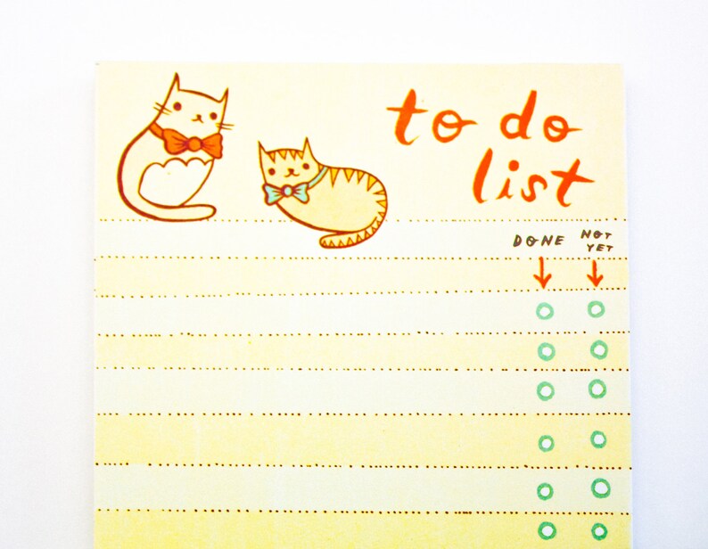 May include: A yellow to-do list notepad with a cat illustration and the text "to do list". The notepad has a dotted line pattern and a column for marking tasks as done or not yet done.