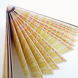 May include: A stack of yellow paper with red circles printed on it. The paper is folded in a fan shape.