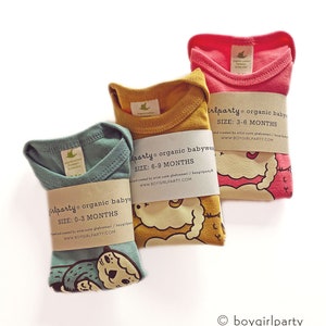 May include: Three organic cotton baby onesies in different colors and sizes. The onesies feature a cute animal graphic and the text "boygirlparty organic babywear" with the size and website address.