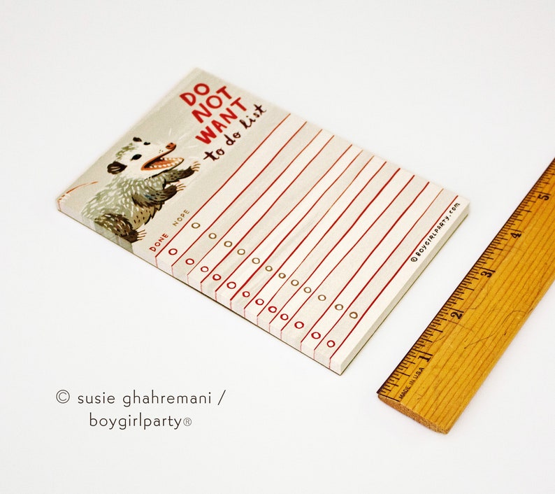 May include: A white notepad with red lines and a black and white illustration of a possum. The notepad has the text "DO NOT WANT to do list" written in red. The notepad has a section for "DONE" and "NOPE" with checkboxes.
