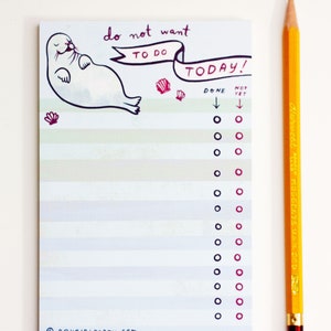 May include: A notepad with the text "to do list notepad" at the top. The notepad has a seal illustration and the words "do not want to do today!" A yellow pencil is next to the notepad.
