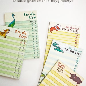 May include: Four different to-do list notepads with colorful illustrations. The notepads have a green, yellow, and blue background with a variety of animal illustrations. The text on the notepads reads "to do list", "like it or not to do list", and "do not want to do list!"