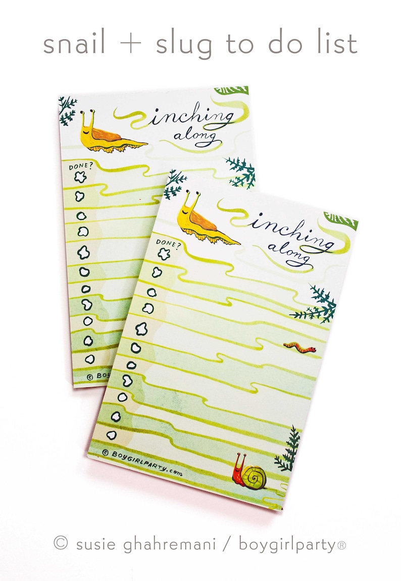 May include: Two yellow and green to-do list notepads with a snail and slug illustration. The notepads have the text "inching along" and "DONE?" printed on them.