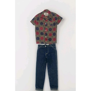 May include: A vintage doll outfit featuring a short-sleeved button-up shirt with a red, blue, and brown floral pattern, paired with dark blue denim jeans. The shirt has a collar and the brand name "Ken" is visible. The jeans have yellow stitching.