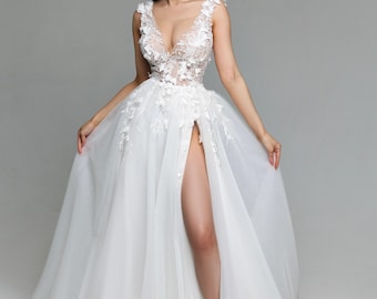 May include: A white wedding dress with a plunging neckline and a high slit. The dress is adorned with delicate floral appliques and a tulle skirt.