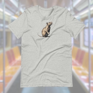May include: A heather grey t-shirt with a graphic of a brown rat standing on its hind legs.
