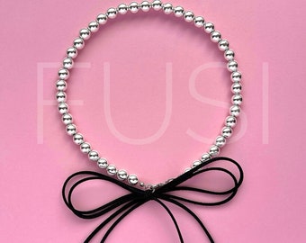 Trendy hematite necklace with bow. Choker bow. Decoration with a bow. Bow on the neck