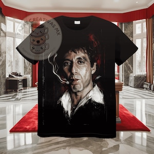 Pode incluir: Camiseta preta com uma estampa gr&aacute;fica de um homem fumando um cigarro. O homem tem cabelo escuro e uma express&atilde;o s&eacute;ria. O fundo &eacute; de cor vermelha escura.