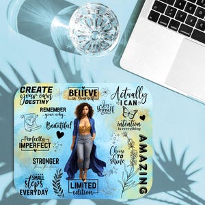 May include: A rectangular mousepad with a watercolor design featuring a woman and inspirational text. The mousepad has a blue and yellow background with phrases like "Create Your Own Destiny" and "Believe in Yourself."