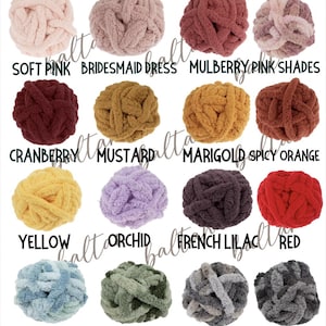 May include: A collection of colorful yarn balls in various shades, including pink, yellow, and blue. Each ball is labeled with its color name, such as "Soft Pink," "Mustard," and "Red." The yarn appears to be thick and chunky, suitable for various crafting projects.