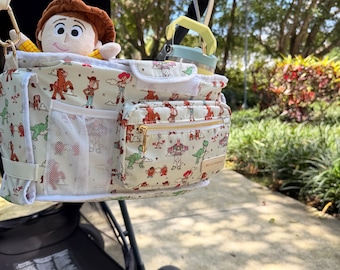 Organizador de cochecito/bolsa para pañales inspirado en Toy Story, ideal para viajes con bebés y parques temáticos.