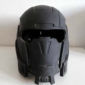 May include: A black plastic helmet with a futuristic design. The helmet has a visor and a face mask.