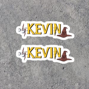 May include: Two stickers with the name "KEVIN" in yellow letters with a lightning bolt and a brown wizard hat.