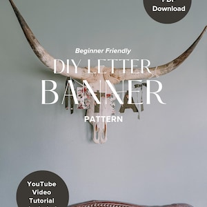 May include: A decorative steer skull with long horns, adorned with a DIY letter banner. The banner features floral patterns and the text "DIY LETTER BANNER PATTERN". Includes an instant PDF download and a YouTube video tutorial.