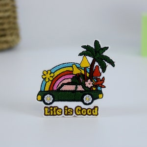 May include: Green car with a rainbow, palm tree, and mushrooms on top. The car has the text "Life is Good" underneath.