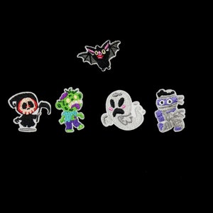 May include: Five embroidered iron-on patches featuring Halloween characters: a ghost, a zombie, a mummy, a bat, and the grim reaper. The patches are white, green, purple, black, and red.