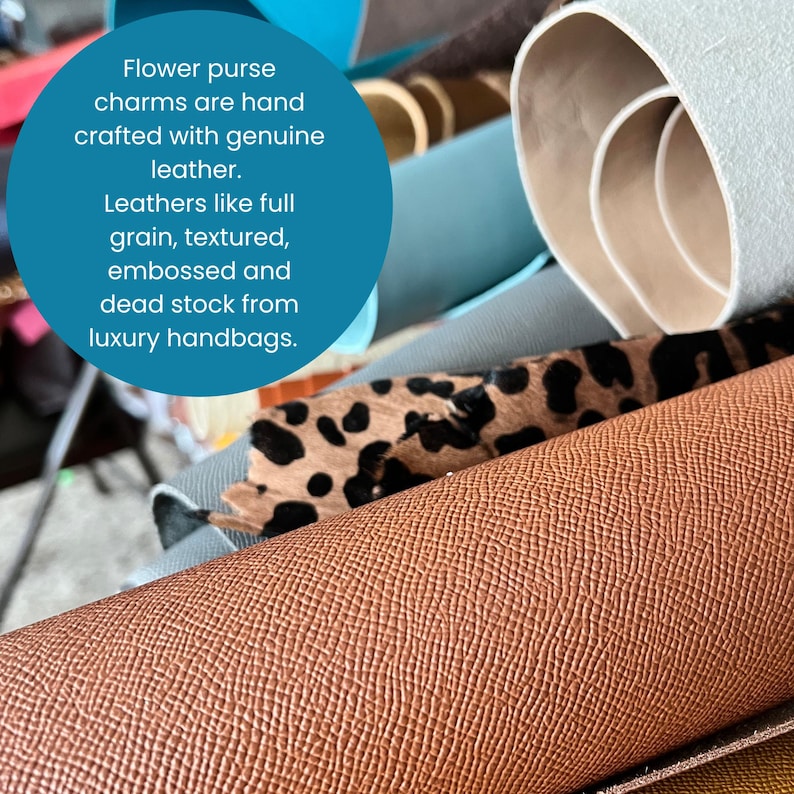 May include: A close-up of various rolls of leather in different colors and textures. The image includes a roll of brown textured leather, a roll of leather with a leopard print, and other rolls of leather in shades of blue and beige. Text in a blue circle reads: Flower purse charms are hand crafted with genuine leather.