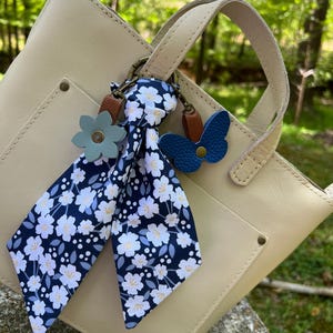 blue flower and butterfly  with floral scarf on white handbag