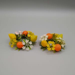 Two small vintage plastic taper candle rings - citrus fruit and flowers