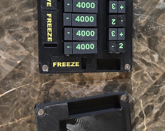 May include: Black electronic control panel with green illuminated numbers and text. The panel has buttons labeled "ACTIVE", "FREEZE", and numbers. A separate black cover is also present.
