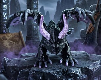 May include: A black dragon figurine with textured scales, large wings, and prominent light purple horns. The creature is posed in a crouched position with sharp claws extended, featuring a dark, rugged appearance with distinct purple accents on the horns and wing membranes.