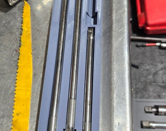 May include: A set of four silver metal extension bars in a gray plastic organizer. The organizer has a red logo with the letters "SCF" on it.