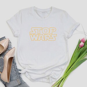 a t - shirt with the words stop wars on it