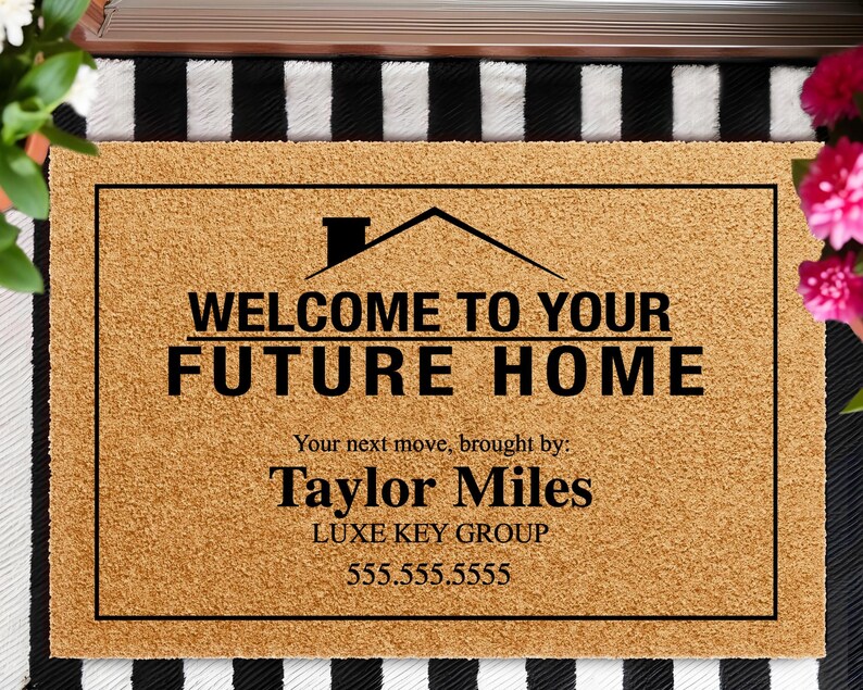 May include: A rectangular doormat made of natural coir fiber. The mat features a black border and text that reads "WELCOME TO YOUR FUTURE HOME." Below the text is "Your next move, brought by: Taylor Miles LUXE KEY GROUP 555.555.5555."