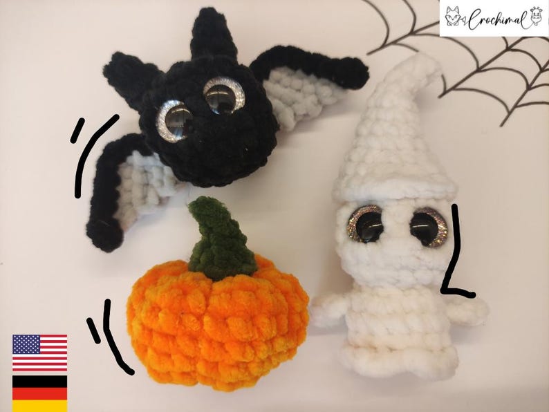 May include: Three crocheted Halloween decorations: a black bat with white wings, a white ghost with googly eyes, and an orange pumpkin with a green stem.