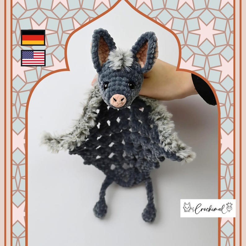 May include: A handmade crochet bat plushie in shades of gray and black, with a pink nose and inner ears. The bat has large ears and outstretched wings. The plushie is held against a patterned background. The logo "Crochimal" is visible.