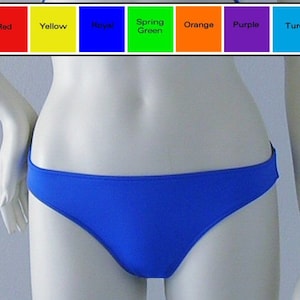 May include: A royal blue bikini bottom with a simple design. The bikini bottom is made of a smooth, stretchy fabric.