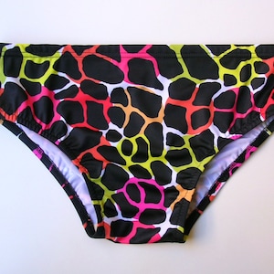 May include: Black swim trunks with a colorful abstract animal print pattern. The print features shades of pink, orange, yellow, and green.