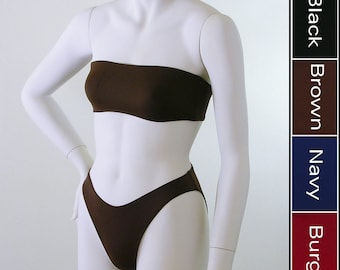 May include: A brown bandeau top and matching bikini bottoms displayed on a mannequin. The image also shows a color chart with the options of black, brown, navy, and burgundy. The swimwear is made of a smooth, solid fabric.