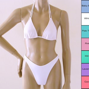 May include: White bikini top and bottom with a halter style top and high-cut bottom.