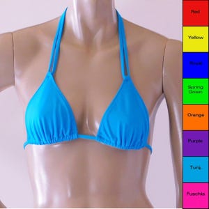 May include: A bright blue bikini top with adjustable straps. The top is made of a smooth, stretchy fabric.