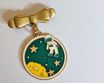 Astronaut enamel brooch on vintage brass bow pin