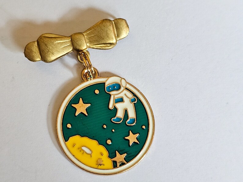 Astronaut enamel brooch on vintage brass bow pin image 1