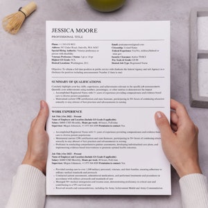Recruiter holding a Military federal resume template in hand