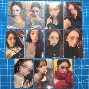 May include: A collection of ten rectangular photo cards featuring portraits of a young person with long dark hair in various outfits, including a grey Washington shirt, a black top with a cross necklace, and a red faux fur garment, arranged in a grid.