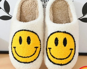 ¡Entra en un arcoíris con nuestras pantuflas con cara sonriente de piel sintética esponjosa! Disponible en varios colores vibrantes para brindar la máxima comodidad y comodidad en el hogar.