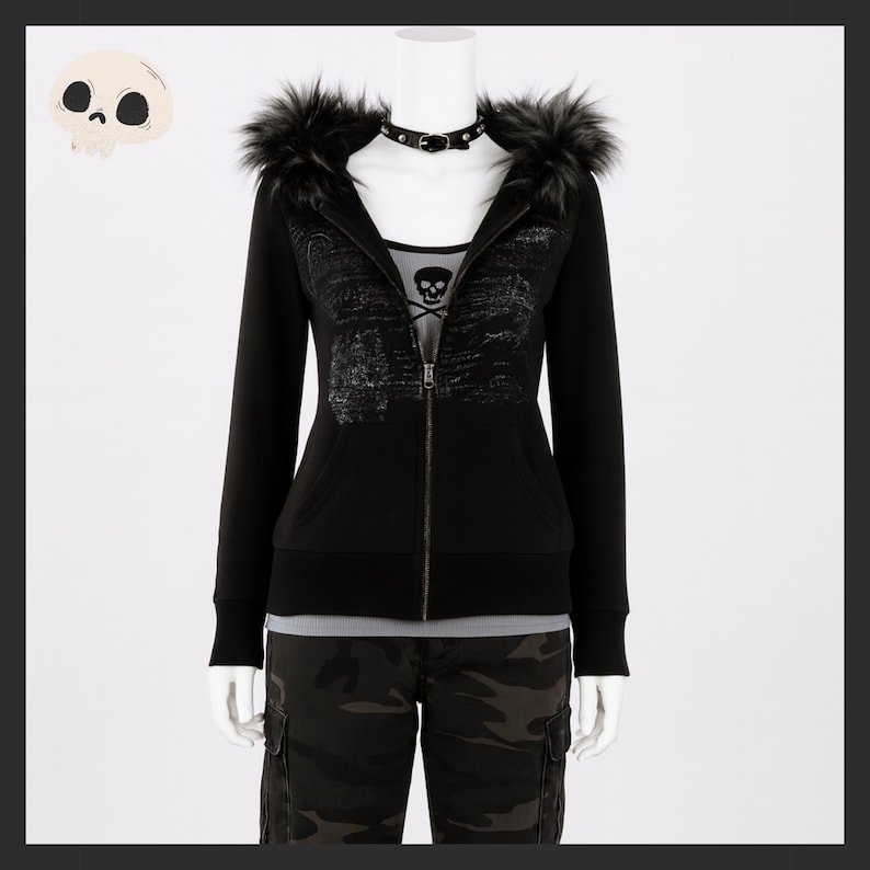 May include: Black zip-up hoodie with faux fur trim on the hood. The hoodie features a skull graphic on the front and is paired with camouflage pants. A black choker necklace is visible. The mannequin is on a white background.