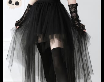 May include: Black tulle skirt with a high-low hemline, paired with black thigh-high stockings and lace fingerless gloves. The outfit has a gothic aesthetic. A cartoon skull is in the upper left corner.