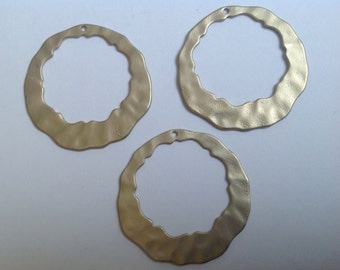 3 large gold wavy circles with per drilled hole