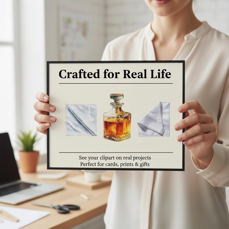 May include: A framed print featuring a watercolor illustration of a decanter with amber liquid and two folded napkins. The text "Crafted for Real Life" is at the top, with additional text at the bottom.
